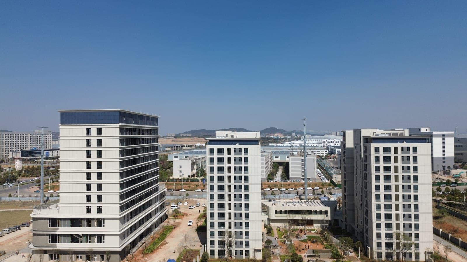 Blue BIPV parapet walls on high-rise towers