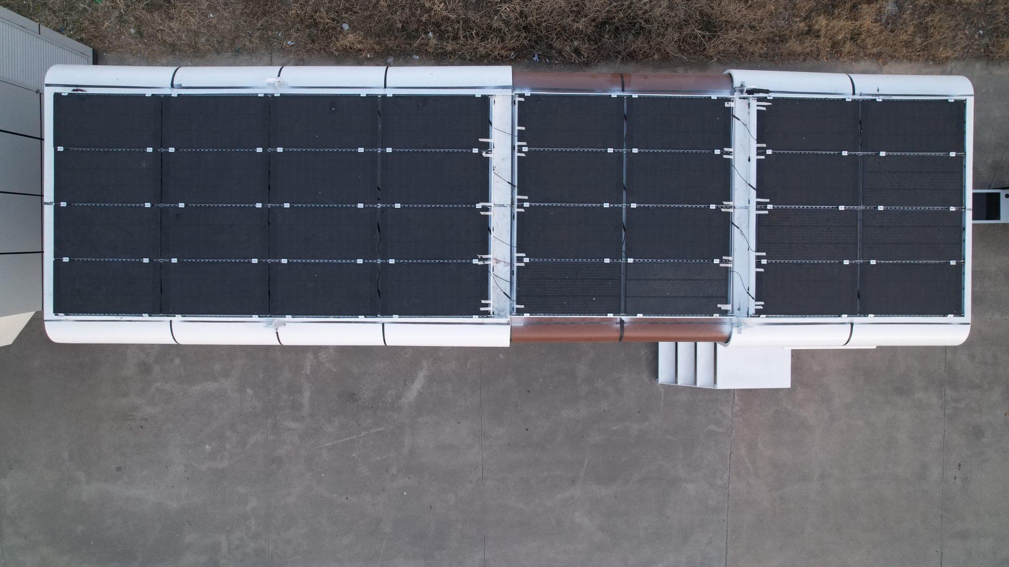 Aerial view of a building unit with a full photovoltaic roof